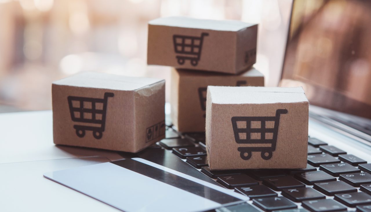 1939658200 Shopping online. Credit card and cardboard box with a shopping cart logo on laptop keyboard. Shopping service on The online web. offers home delivery