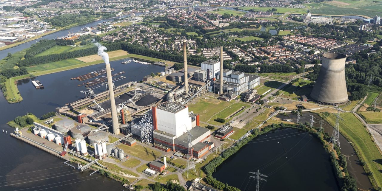 19 July 2016, Geertruidenberg, Holland. Aerial view of the AMERCENTRALE, a coal and biomass fired Essent powerplant. It's located at the river Amer. In the back the town of GEERTRUIDENBERG. 