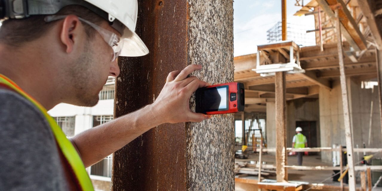 Jobsite supervisor takes horizontal measurement with PD-C_PD-CS from a steel beam, side view